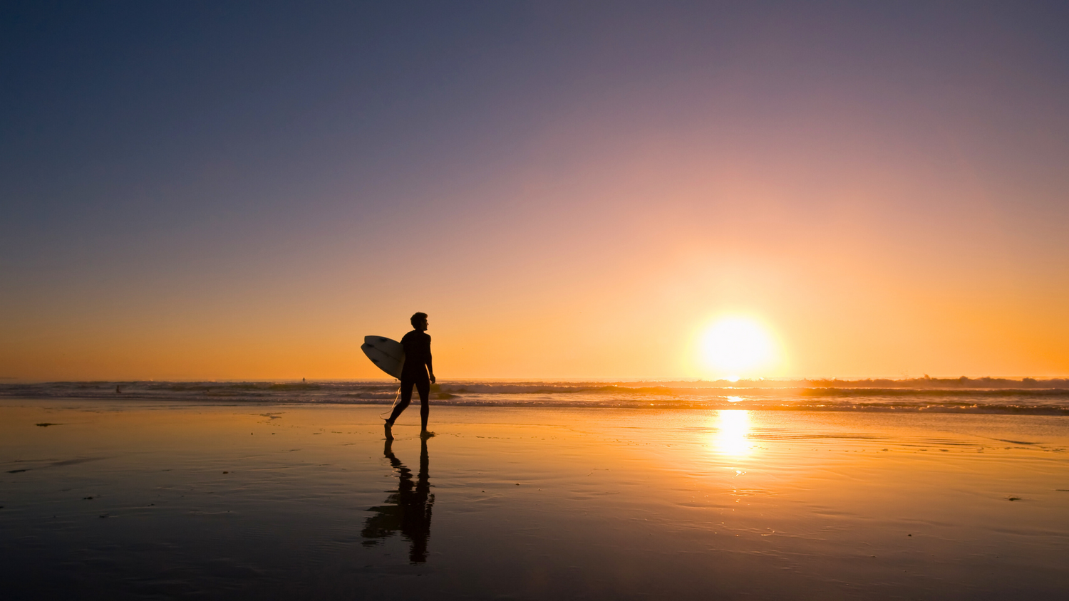 Surfer carrying a surfboard while riding an e-bike to the beach, illustrating the convenience and eco-friendliness of electric bikes for surfers and skaters